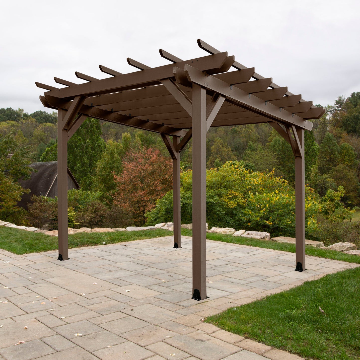 Quality built, 100% USA made pergola sitting on patio with outdoor landscaping. Sequoia Professional outdoor furniture proudly sold by Ember & Oasis! Featuring a 12-year residential limited warranty.