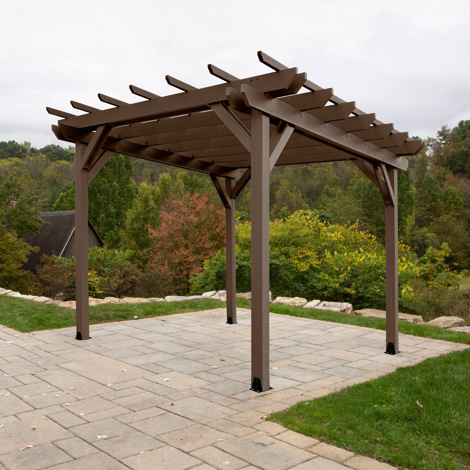 Quality built, 100% USA made pergola sitting on patio with outdoor landscaping. Sequoia Professional outdoor furniture proudly sold by Ember & Oasis! Featuring a 12-year residential limited warranty.